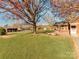 Spacious backyard with mature trees and detached structures at 491 Lytton St, Troutman, NC 28166