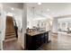 Kitchen island with granite countertop and dark brown cabinets at 5019 Elementary View Dr, Charlotte, NC 28269