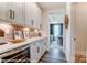 White cabinets and quartz countertop butler's pantry with wine cooler at 5238 Verona Rd # 78, Charlotte, NC 28213