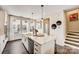 Open kitchen with large island, white cabinetry and stainless steel appliances at 703 Hoke Ln, Davidson, NC 28036