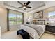 Spacious main bedroom with king-size bed, tray ceiling, and large windows at 703 Hoke Ln, Davidson, NC 28036