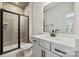 Bathroom with gray tile shower, white vanity, and modern fixtures at 711 Hoke Ln, Davidson, NC 28036