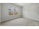 Spacious bedroom with neutral carpeting and large windows at 711 Hoke Ln, Davidson, NC 28036