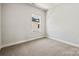 Well-lit bedroom with a window and neutral walls at 711 Hoke Ln, Davidson, NC 28036