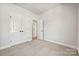 Simple bedroom with double doors and carpet flooring at 711 Hoke Ln, Davidson, NC 28036