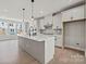 Modern kitchen with island, stainless steel appliances, and white cabinets at 711 Hoke Ln, Davidson, NC 28036