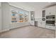 Eat-in kitchen with white cabinets, built-in shelving, and stainless steel appliances at 711 Hoke Ln, Davidson, NC 28036