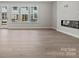 Living room with hardwood floors, fireplace, and large windows at 711 Hoke Ln, Davidson, NC 28036