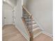 Modern staircase with light wood steps and dark metal railing at 711 Hoke Ln, Davidson, NC 28036