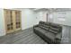 Finished basement recreation area with gray vinyl flooring and sofa at 7526 Dorn Cir, Charlotte, NC 28212