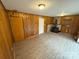 Spacious basement living area with wood paneling and a wood-burning stove at 7526 Dorn Cir, Charlotte, NC 28212