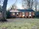 Brick ranch home with landscaped yard and a spacious front lawn at 7526 Dorn Cir, Charlotte, NC 28212