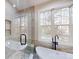 Spacious bathroom featuring a soaking tub, walk-in shower, and large windows at 8046 Lucky Creek Ln, Denver, NC 28037