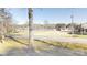 View of a neighborhood street with a lake in the background and surrounding trees at 8046 Lucky Creek Ln, Denver, NC 28037