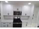 Modern kitchen with white shaker cabinets, quartz countertops, and stainless steel appliances at 908 E Main St, Maiden, NC 28650