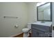 Half bathroom with gray vanity and updated fixtures at 9709 Calpher Ct, Matthews, NC 28105