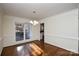 Dining area with hardwood floors, large windows, and crown molding at 9709 Calpher Ct, Matthews, NC 28105