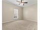 Spacious bedroom with ceiling fan and window at 10302 Sawtimber Ct, Huntersville, NC 28078