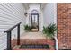 Inviting front entrance with brick steps and potted plants at 10302 Sawtimber Ct, Huntersville, NC 28078