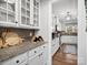 Butlers pantry with white cabinets and granite countertops at 10827 Hadrians Walk Ct, Mint Hill, NC 28227