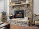 Stone fireplace with built-in shelving and mantle at 10827 Hadrians Walk Ct, Mint Hill, NC 28227