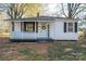 White house with black shutters, front porch, and landscaping at 143 Hallman St, Cherryville, NC 28021