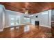 Living room with hardwood floors, fireplace, and access to deck at 1649 Wolf Rd, Iron Station, NC 28080