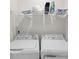 Laundry room with washer, dryer, and shelving at 1725 Aspire St, Charlotte, NC 28262