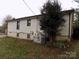 Rear exterior view showing AC unit and partial view of home at 1806 Rhyne Rd, Dallas, NC 28034