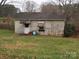 Small, weathered shed with a partially visible door and window at 1806 Rhyne Rd, Dallas, NC 28034