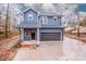 Two-story blue house with a two-car garage and brick steps leading to the front porch at 202 Phillip Dr, Salisbury, NC 28146