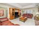 Spacious living room featuring leather sofas, a large TV, and built-in shelving at 2027 Killarney Pl, Charlotte, NC 28262