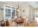 Breakfast room with round table and chairs, abundant natural light, and views of the backyard at 2930 Phillips Fairway Dr, Charlotte, NC 28216