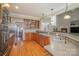 Kitchen with wood cabinets, stainless steel appliances, and a view of the dining area at 2930 Phillips Fairway Dr, Charlotte, NC 28216