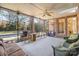 Screened-in porch with wicker furniture, ceiling fan, and a view of the pool at 2930 Phillips Fairway Dr, Charlotte, NC 28216