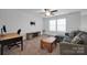 Carpeted loft with a ceiling fan, sectional sofa, coffee table, and a workspace at 3611 Antrim Pl, Kannapolis, NC 28081