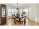 Bright dining room with hardwood floors, a large table, and a view of the kitchen at 3712 Alden St, Indian Trail, NC 28079