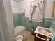 Clean bathroom with light green tile and a tub shower at 601 Sherman St, Badin, NC 28009