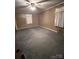 Spacious bedroom with wood paneled walls and carpet at 601 Sherman St, Badin, NC 28009
