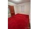 Simple bedroom with red carpeting and a window at 601 Sherman St, Badin, NC 28009