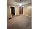 Quaint dining area with wood paneled walls and carpet at 601 Sherman St, Badin, NC 28009