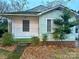 Charming ranch house with green siding and established landscaping at 601 Sherman St, Badin, NC 28009