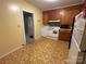 Retro kitchen with wood cabinets and tile floor at 601 Sherman St, Badin, NC 28009
