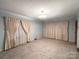 Bright living room featuring light walls and carpeted floor at 601 Sherman St, Badin, NC 28009