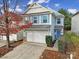 Two-story house with gray siding, attached garage, and landscaping at 8411 Washoe Pine Ln, Charlotte, NC 28215