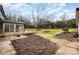 Landscaped backyard with a large green space and mature trees at 8823 Dartmoor Pl, Mint Hill, NC 28227