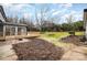 Landscaped backyard with a large green space and mature trees at 8823 Dartmoor Pl, Mint Hill, NC 28227