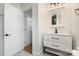 Clean bathroom with white vanity, modern fixtures and an exterior door at 8823 Dartmoor Pl, Mint Hill, NC 28227