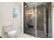Stylish bathroom with a large walk-in shower and modern vanity at 8823 Dartmoor Pl, Mint Hill, NC 28227