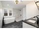 Bathroom with soaking tub, walk-in shower, and marble tile at 8823 Dartmoor Pl, Mint Hill, NC 28227